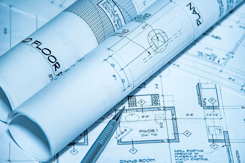 rolled architectural blueprints and floor plan for a basement remodel