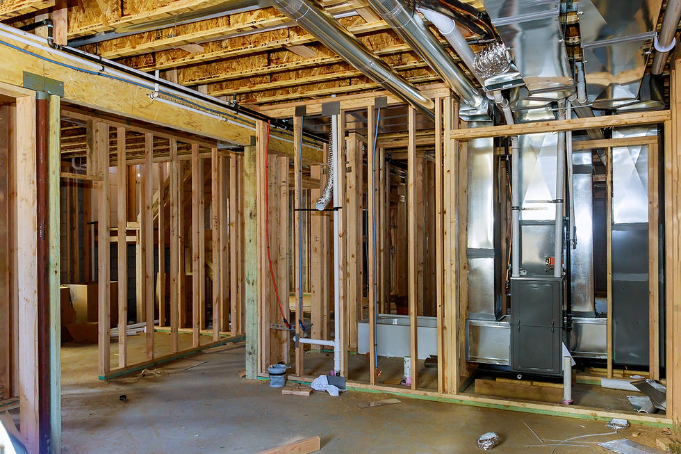 basement wall framing with plumbing and ductwork running through studs