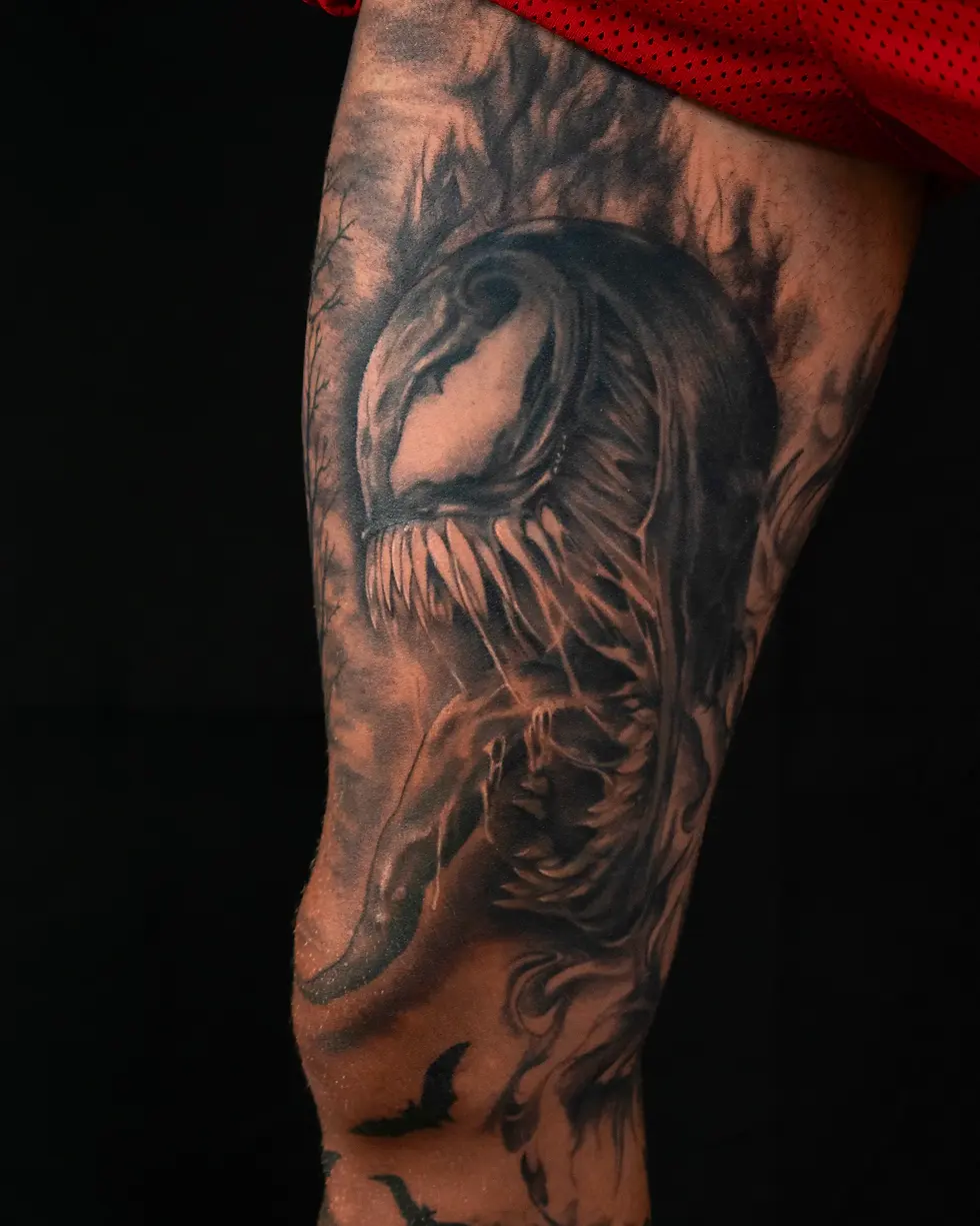 Realistic black and grey Venom (Marvel) portrait thigh tattoo, by Domi