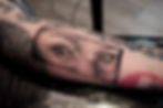 Realistic black and grey forearm tattoo of human eyes, by Dagga