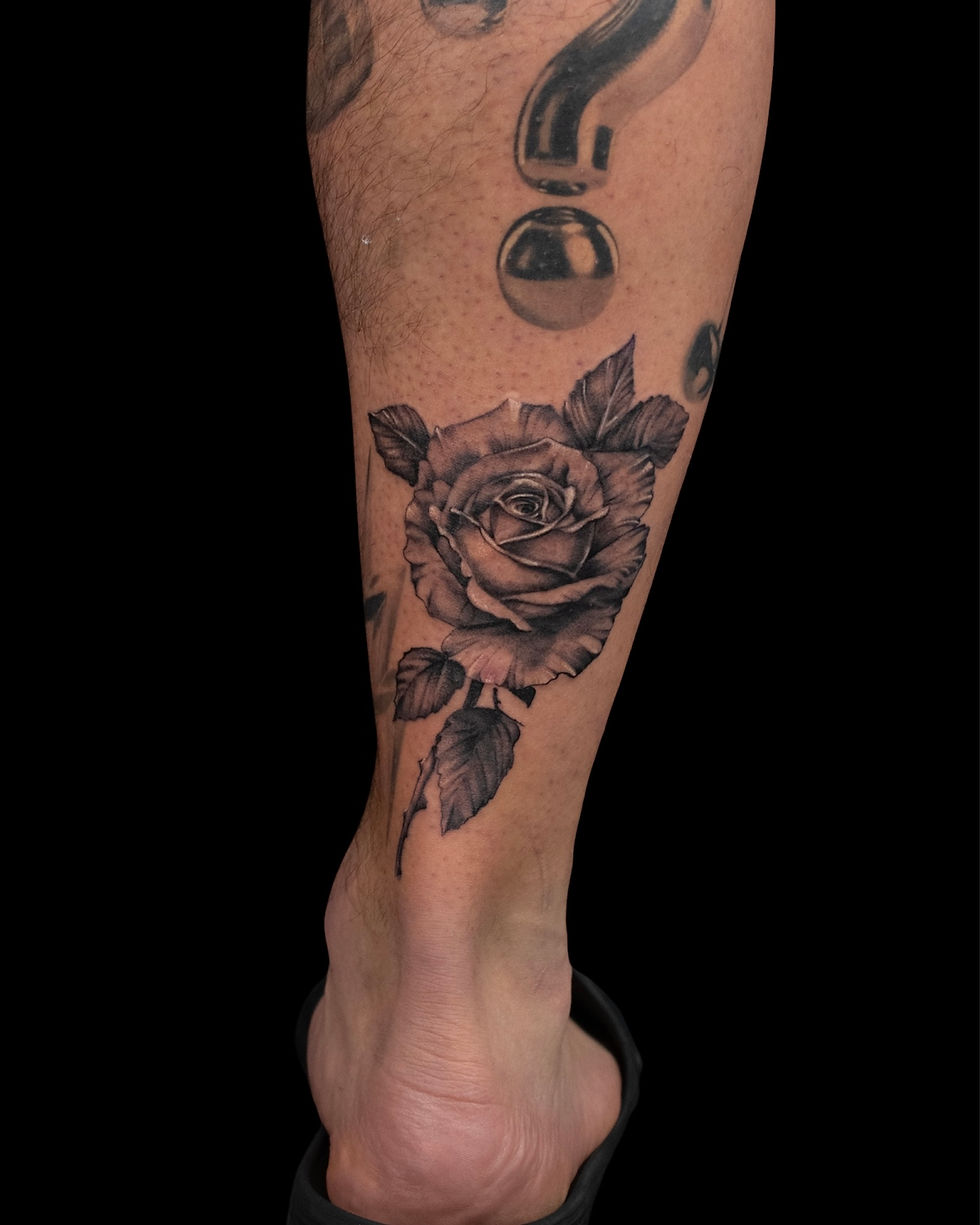 Realistic black and grey rose calf tattoo, by Domi