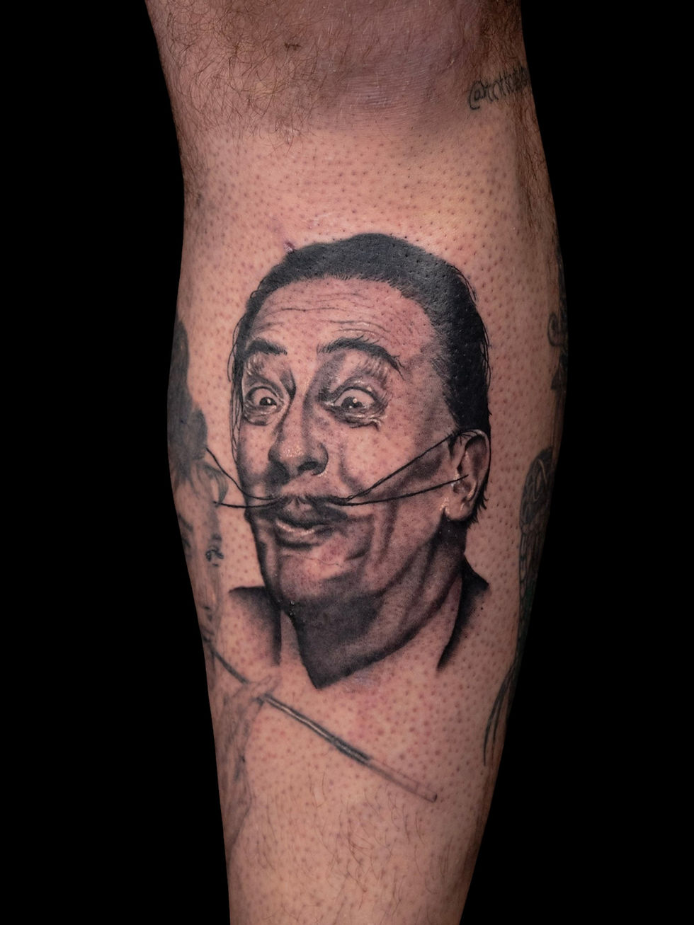 Realistic black and grey Salvador Dalí tattoo portrait, by Domi