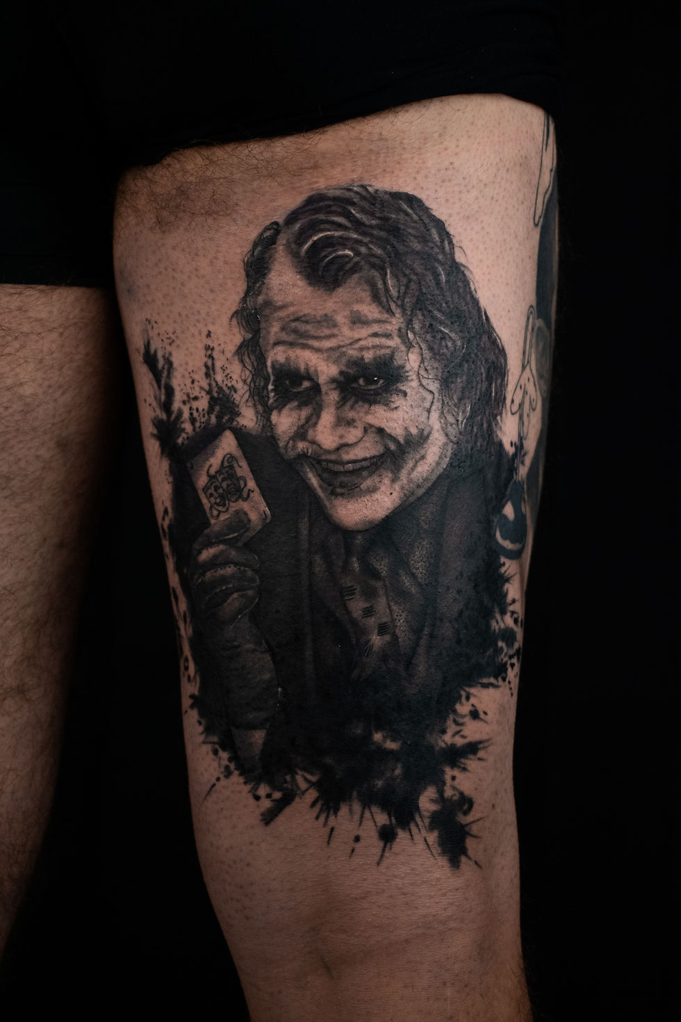Realistic black and grey Heath Ledger (Joker) tattoo portrait, by Domi