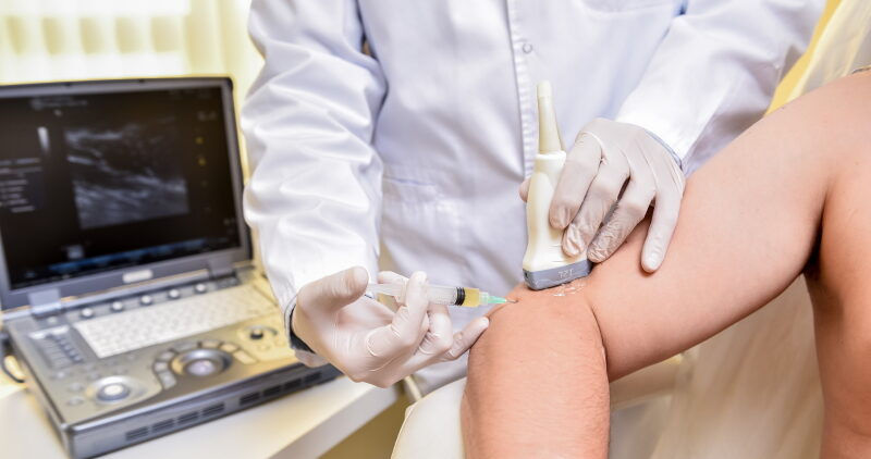 Medical professional administering a PRP injection into a patient’s elbow to promote healing and relieve pain naturally.