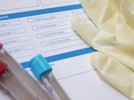 close-up of a gloved hand holding a PRP syringe and test tube.