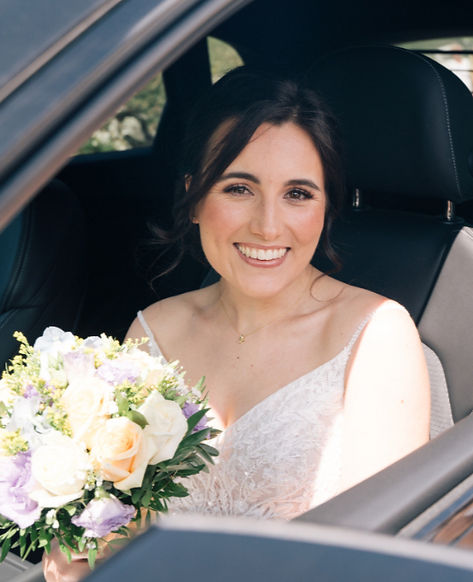 A happy bride in her bridal car