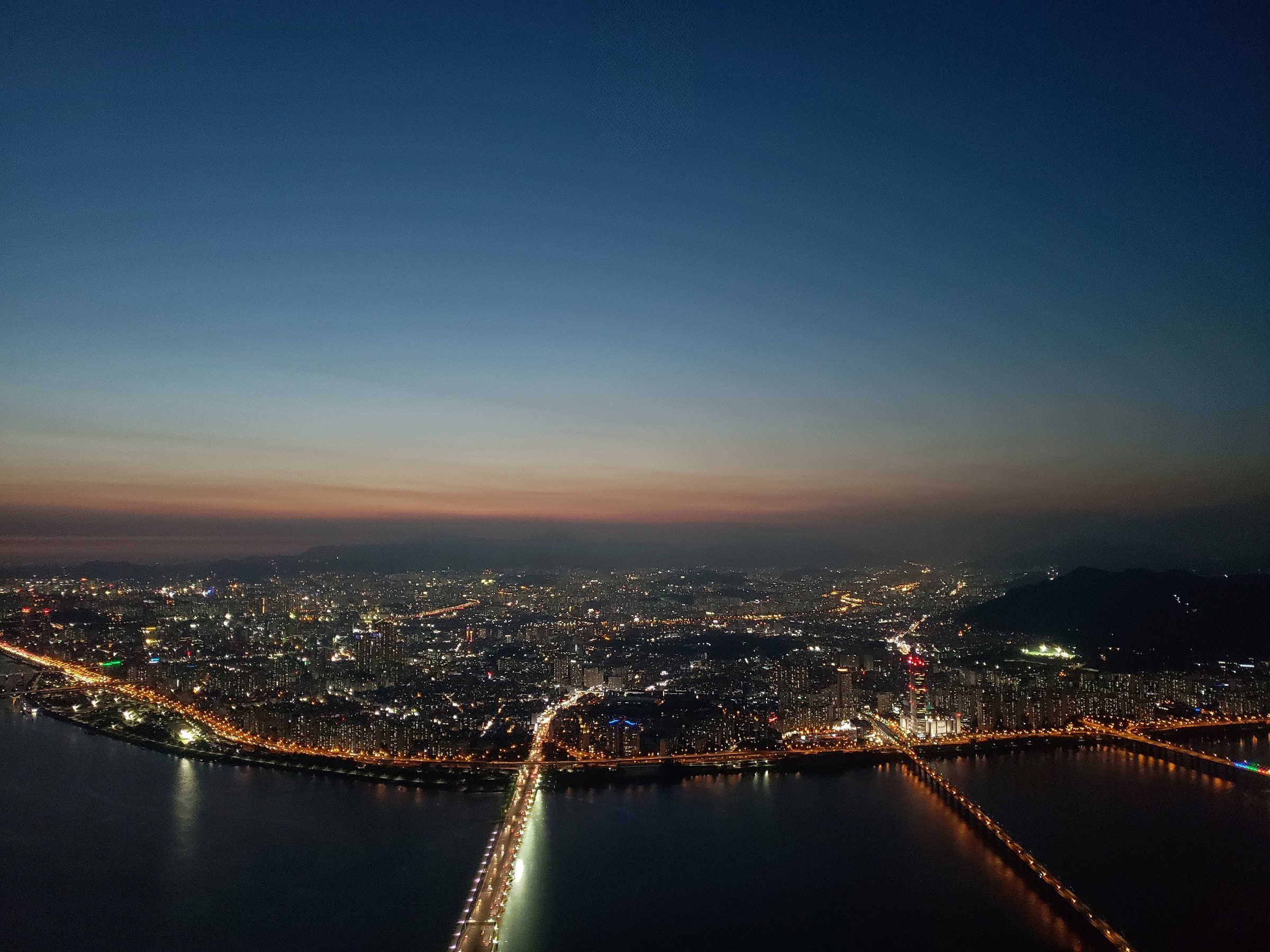 The Seoul skyline and the Han River at night.
