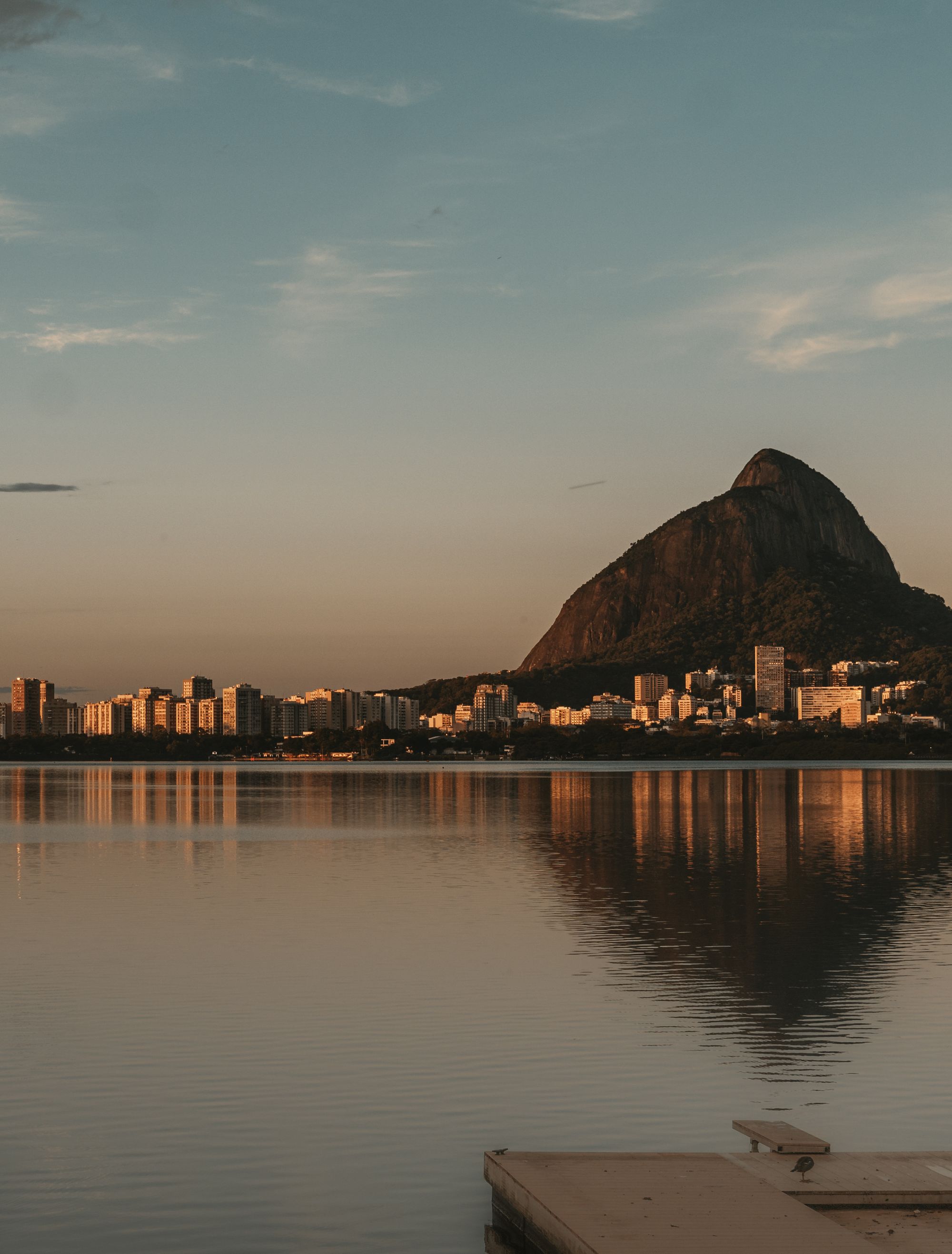 The Rio de Janeiro skyline at dusk, seen across the Lagoa Rodrigo de Freitas.