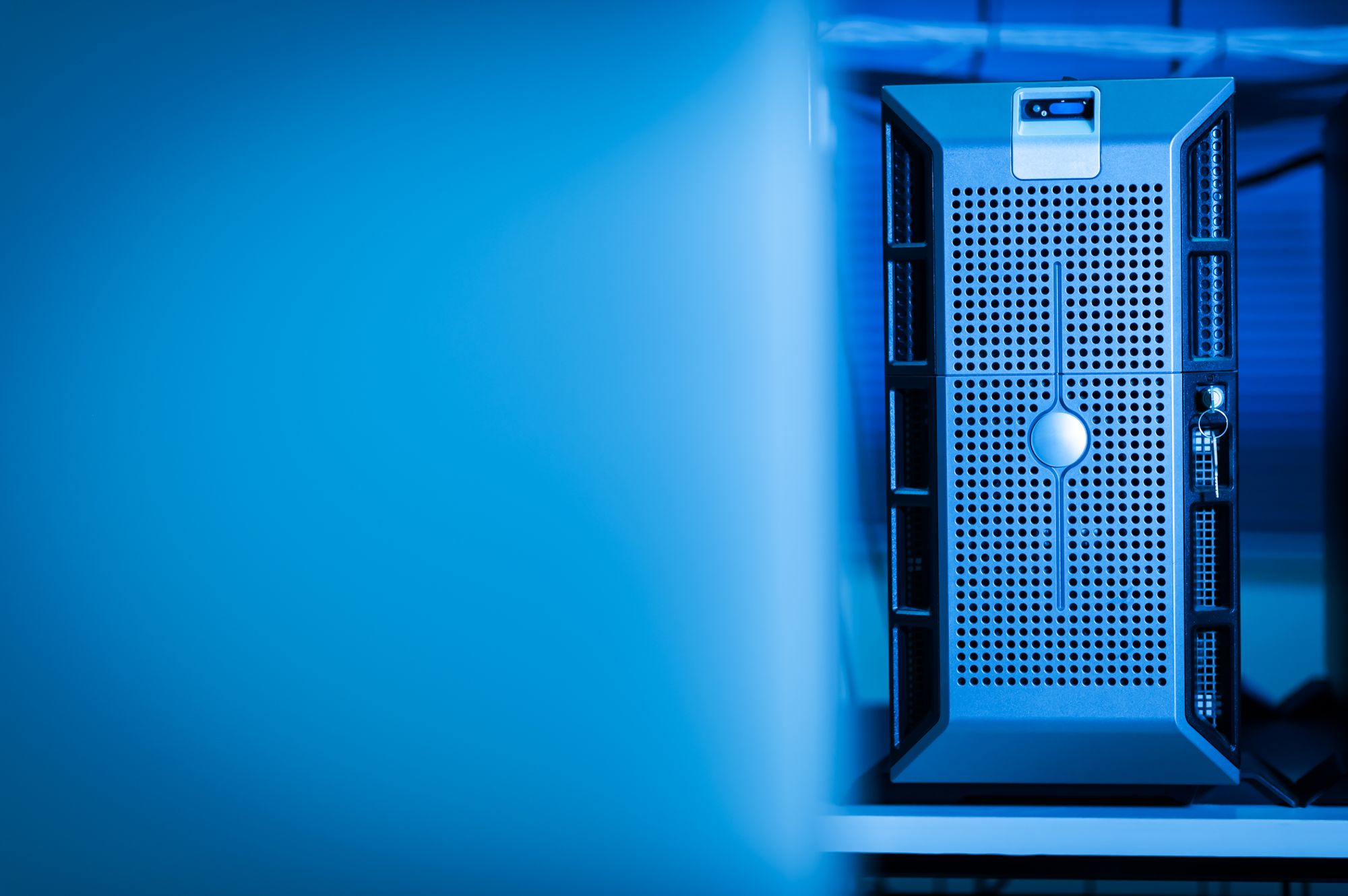 A server rack lit in blue in a data centre.