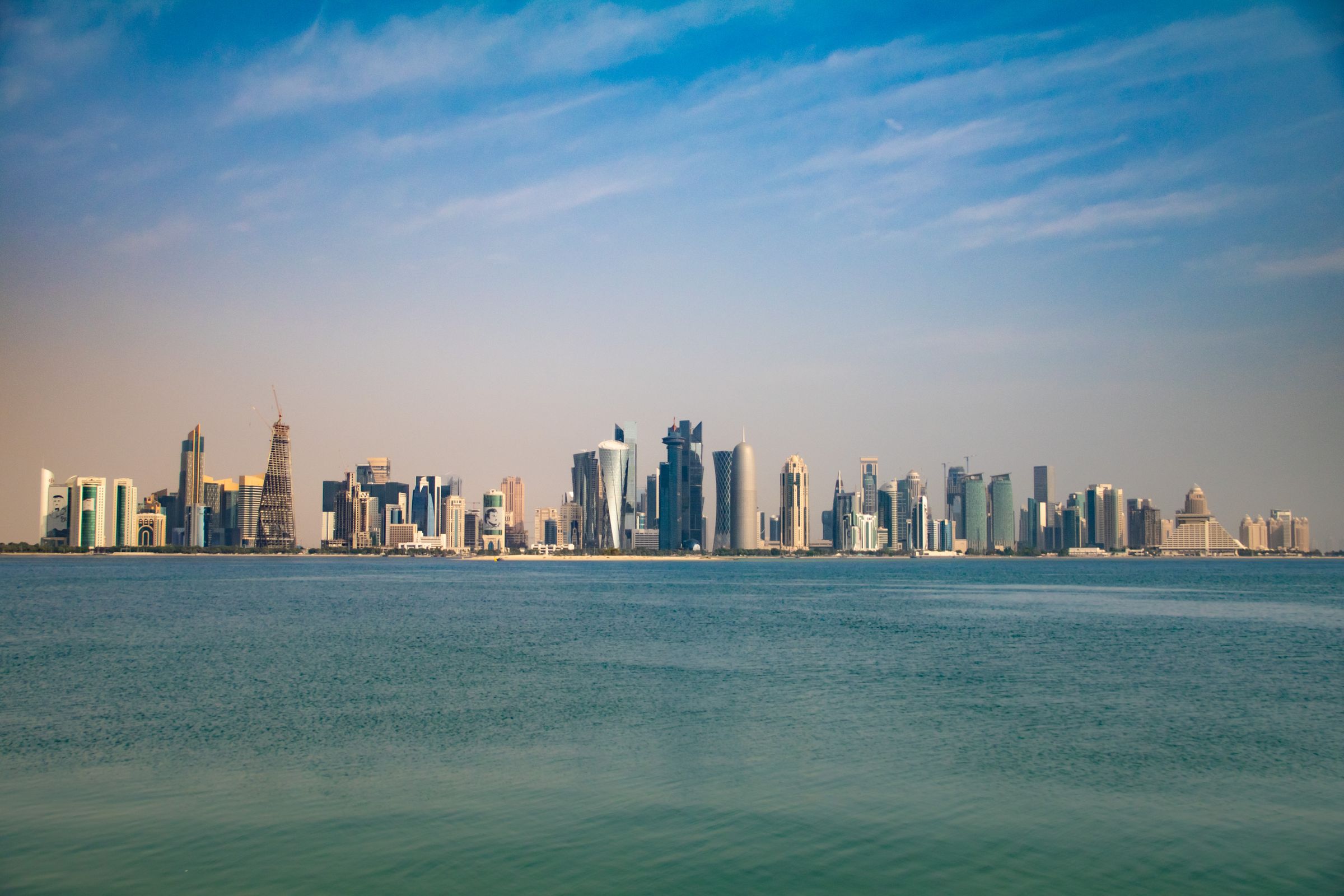 The Doha skyline across the water, with the West Bay towers.