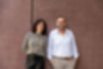 AnalysePlus Unternehmensberatung Portrait vom Geschaeftsfuehrer Marko Struck und IT-Spezialistin Nadia Mueller vor einer Roten Wand