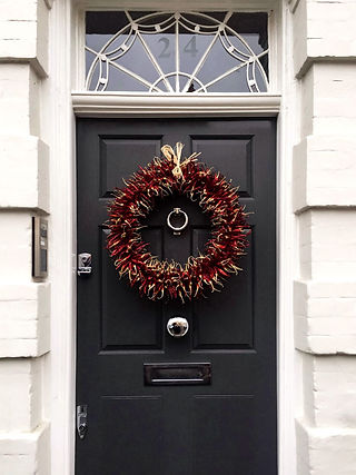 a capsicum garland dressing a black door