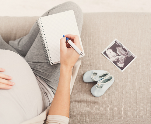Pregnant woman taking notes during her hypnobirthing class