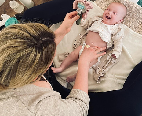 mum bonding with baby as she gives her a massage