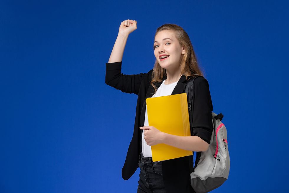 front-view-female-student-black-jacket-wearing-backpack-holding-yellow-files-blue-desk-sch
