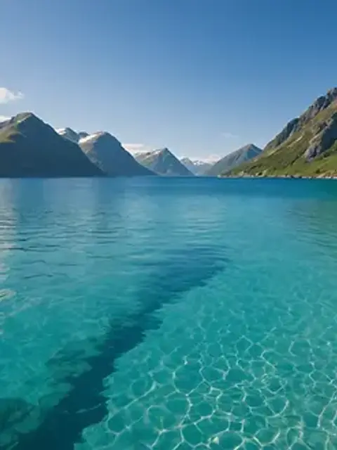 Eye-level view of clear blue water at Haukland Beach
