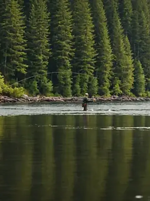 Eye-level view of a fisherman casting his line on the Ketchikan River