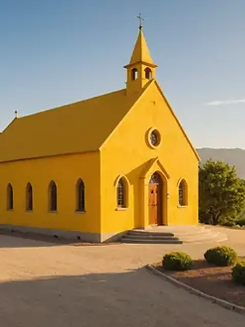 Eye-level view of the Alto Vista Chapel with its distinctive yellow exterior