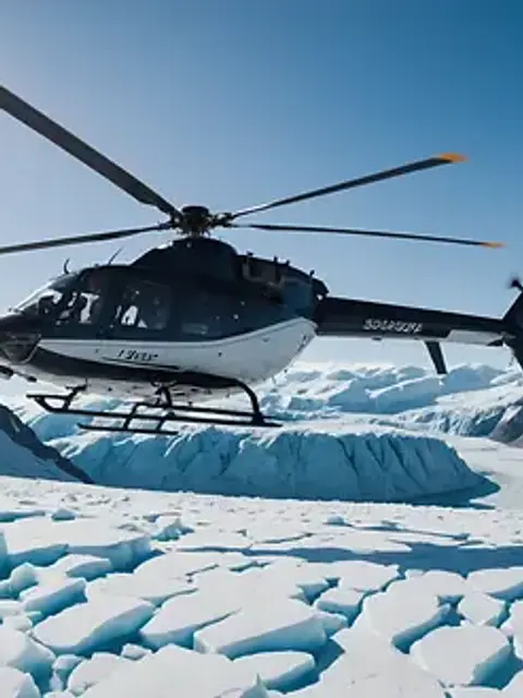 Wide angle view of a helicopter flying over a glacier landscape