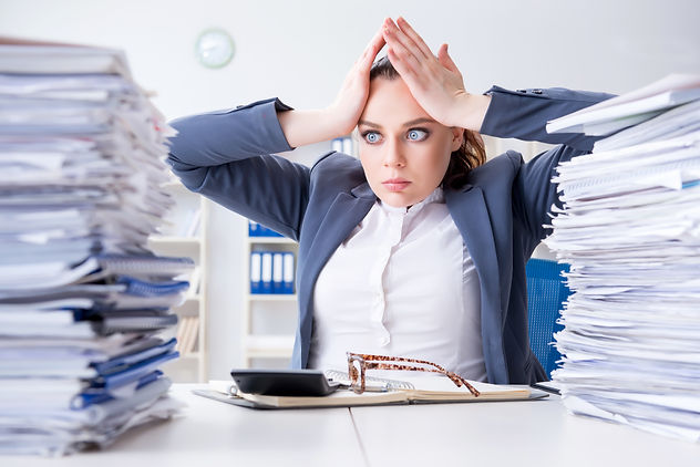 Overhelmed busniesswoman holds her head as she looks at mounds of paperwork. This could represent the stress from trying to deal with private practice paperwork. Contact Private Practice Startup to learn of our free HIPAA forms in Fort Lauderdale, FL to support your practice.