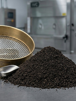 Macro photography of IVC-38 fine screened engineered biological soil substrate in a laboratory setting.