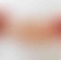 Two hands show a 2 inch gap left after sewing two half-units of a fabric basketball together