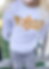 a child wearing a DIY sweatshirt with raw edge appliqué and reverse appliqué spelling out the word VOLS with a flower for the O