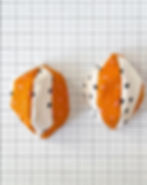 Two 4-piece halves of a fabric basketball sit on a white cutting mat with black lines