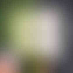 hands using a rotary cutter and a ruler to cut on a previously drawn line