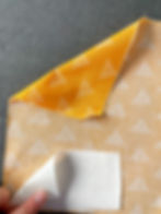 Orange fabric with person adding double-sided fusible