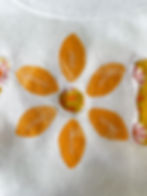 Raw edge applique footballs arranged in the shape of a flower with a reverse appliqué center