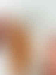 A hand places a white piece of fabric with black stars together with a previously sewn together unit of white and orange fabric