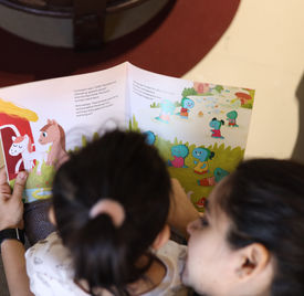 Child Reading Trash to Treasure with Parent.JPG