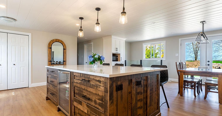 Rustic maple solid wood island stained in brown, featuring black handles and a unique touch to this kitchen in Tavistock ON