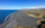 Black sand meets sea from a viewpoint in Dyrholaey during Chase Dekker's Iceland photography workshop.