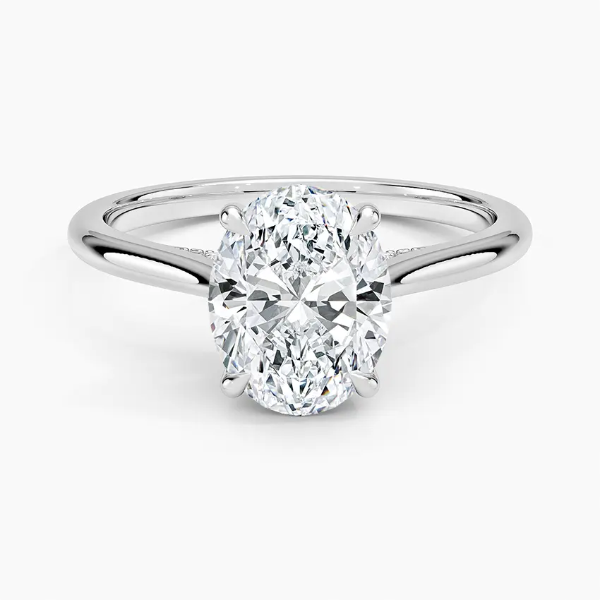 Thumbnail: Remi - 14k Oval Cut Solitaire with Hidden Halo and Studded Bridge