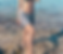 woman on beach, standing in water. modelling crochet cover-up skirt over bikini