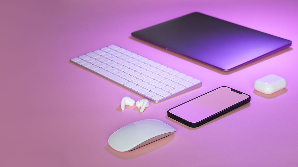 Flat lay of wireless tech gadgets on pink surface, highlighting modern electronics.