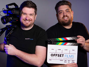 Laurence Scott on Camera and Nathan Maskey holding the slate posing and smiling for camera