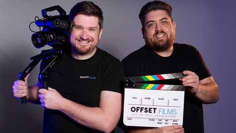 Laurence Scott on Camera and Nathan Maskey holding the slate posing and smiling for camera