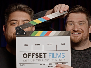 Two smiling men (Nathan and Laurence) pose behind a film clapperboard labelled OFFSET FILMS against a dark studio backdrop.