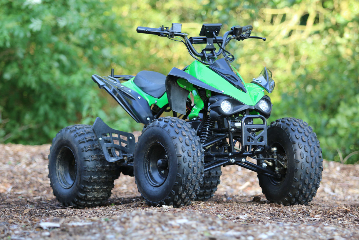 Green electric quad bike on wood chippings