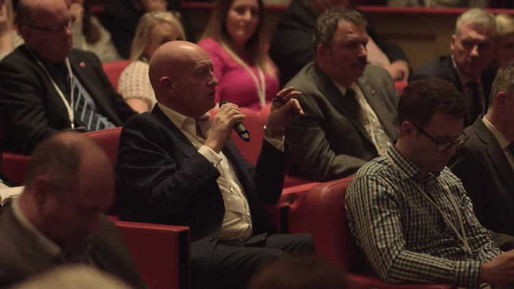 Audience answering question with microphone at conference