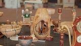 Many finished wood turned pieces on a table
