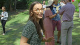 Beautiful women talking to camera at garden party