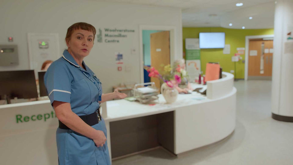 Nurse at Westmorland Macmillan Centre reception desk.