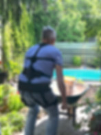 Man wearing Flexa while lifting a wheelbarrow.