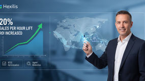 A consultant points to a digital interface displaying a 20% sales increase-per-hour benchmark in outbound.