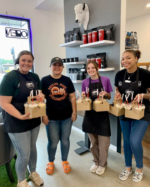 WhiteBuffaloCoffee team members holding coffee orders