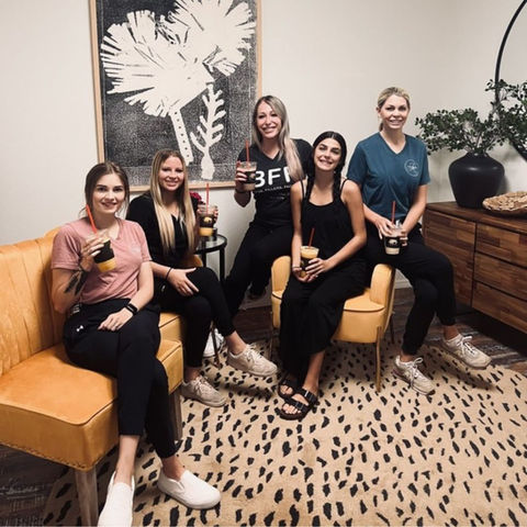 Smiling White Buffalo Coffee team enjoying drinks together